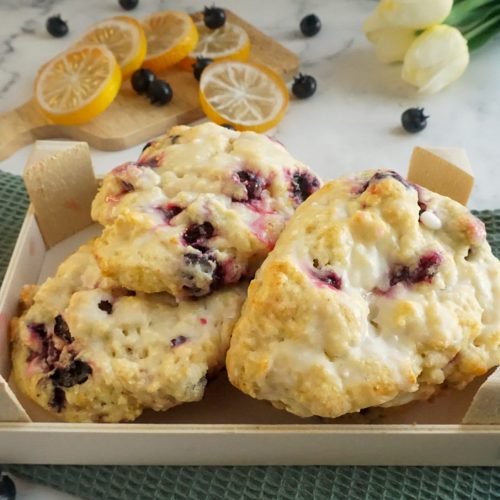 Lemon blueberry scones displayed in a wood crate
